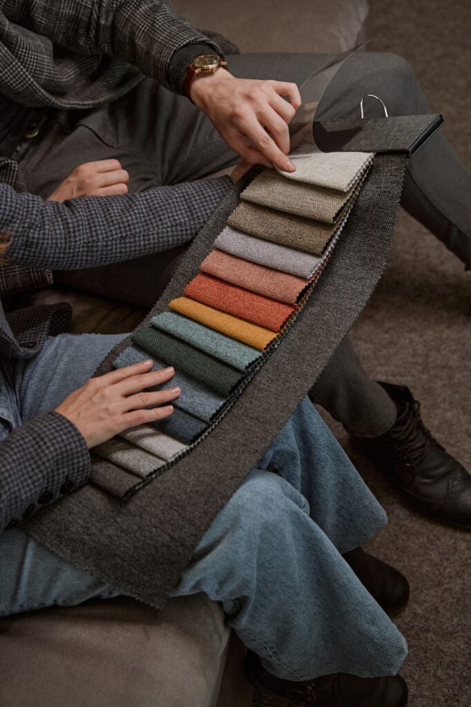 Two people studying swatches in furniture store